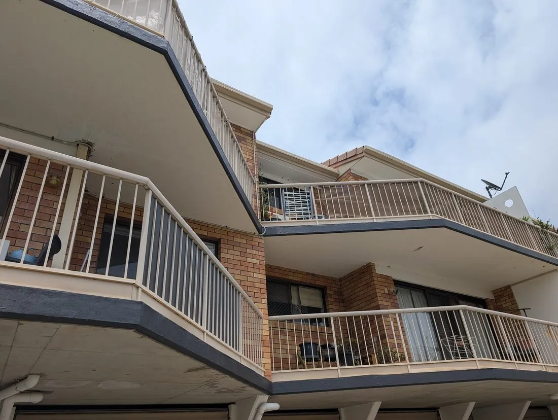 The same apartment balcony fronts and trim repainted clean and crisp