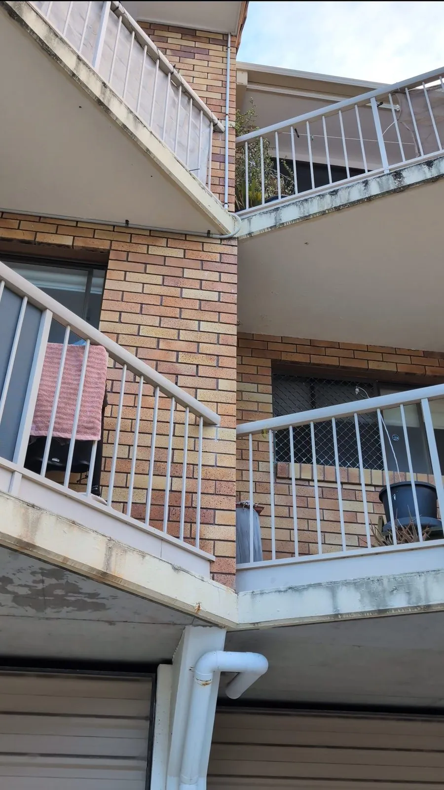Beachside apartment balconies stained with salt and mould before repainting
